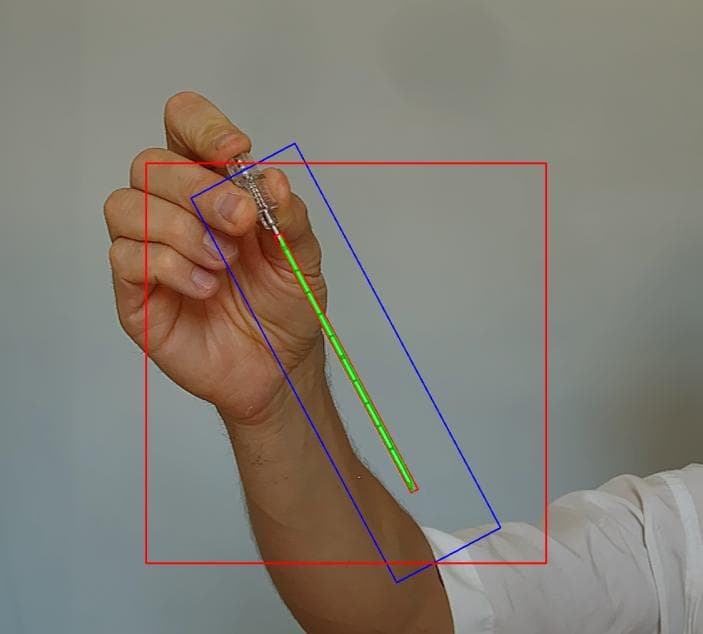 A hand holding a needle, with the hand and the needle outlined by the computer-vision detection